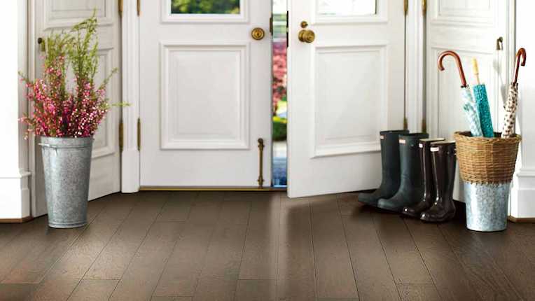 dark stained luxury vinyl plank flooring in an elegant entryway